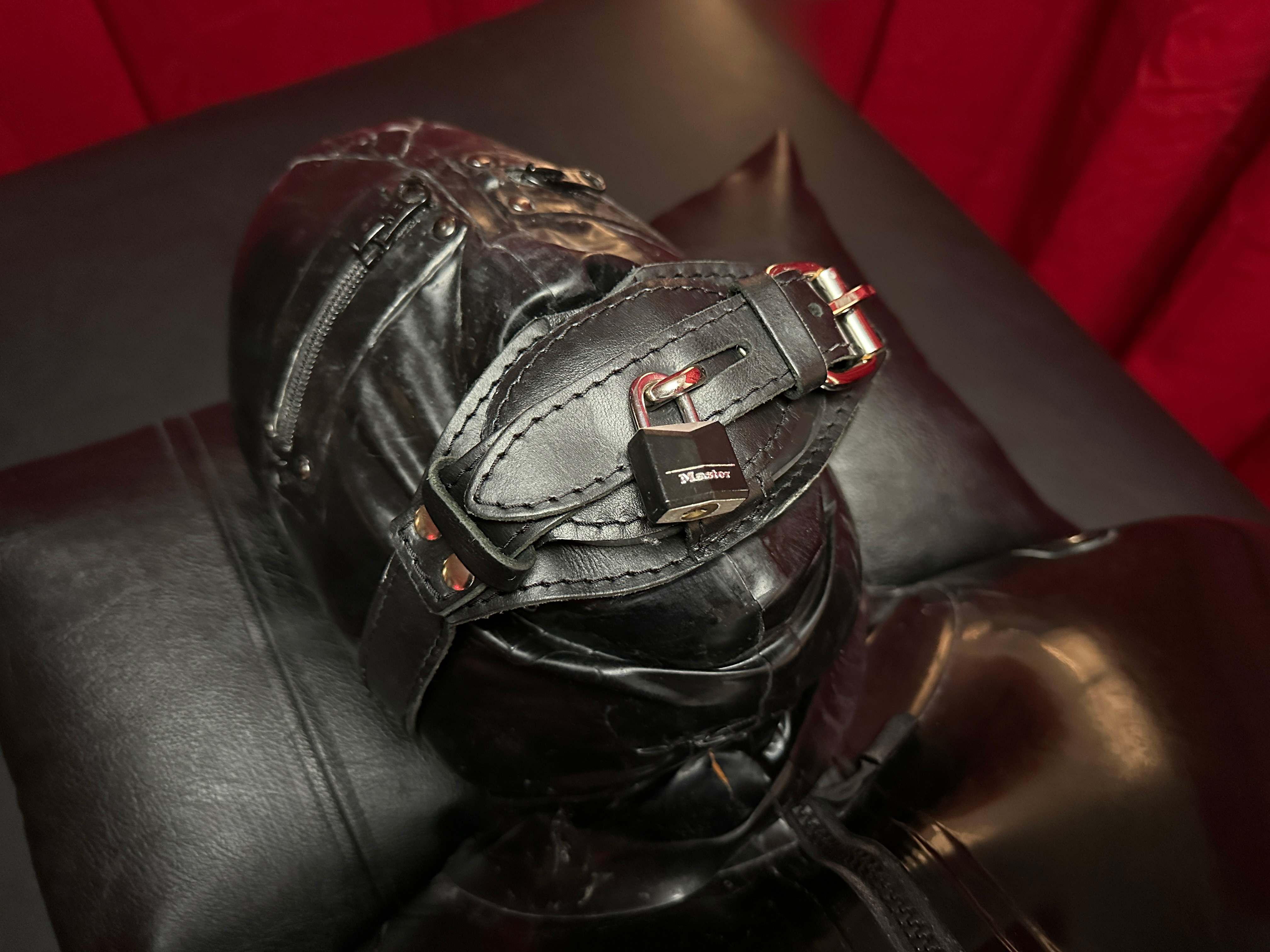 TS Mistress Mia, Dallas Trans Dominatrix and Mistress, controlling a latex gag slave in intense bondage during a private in-person BDSM session in her North Dallas dungeon